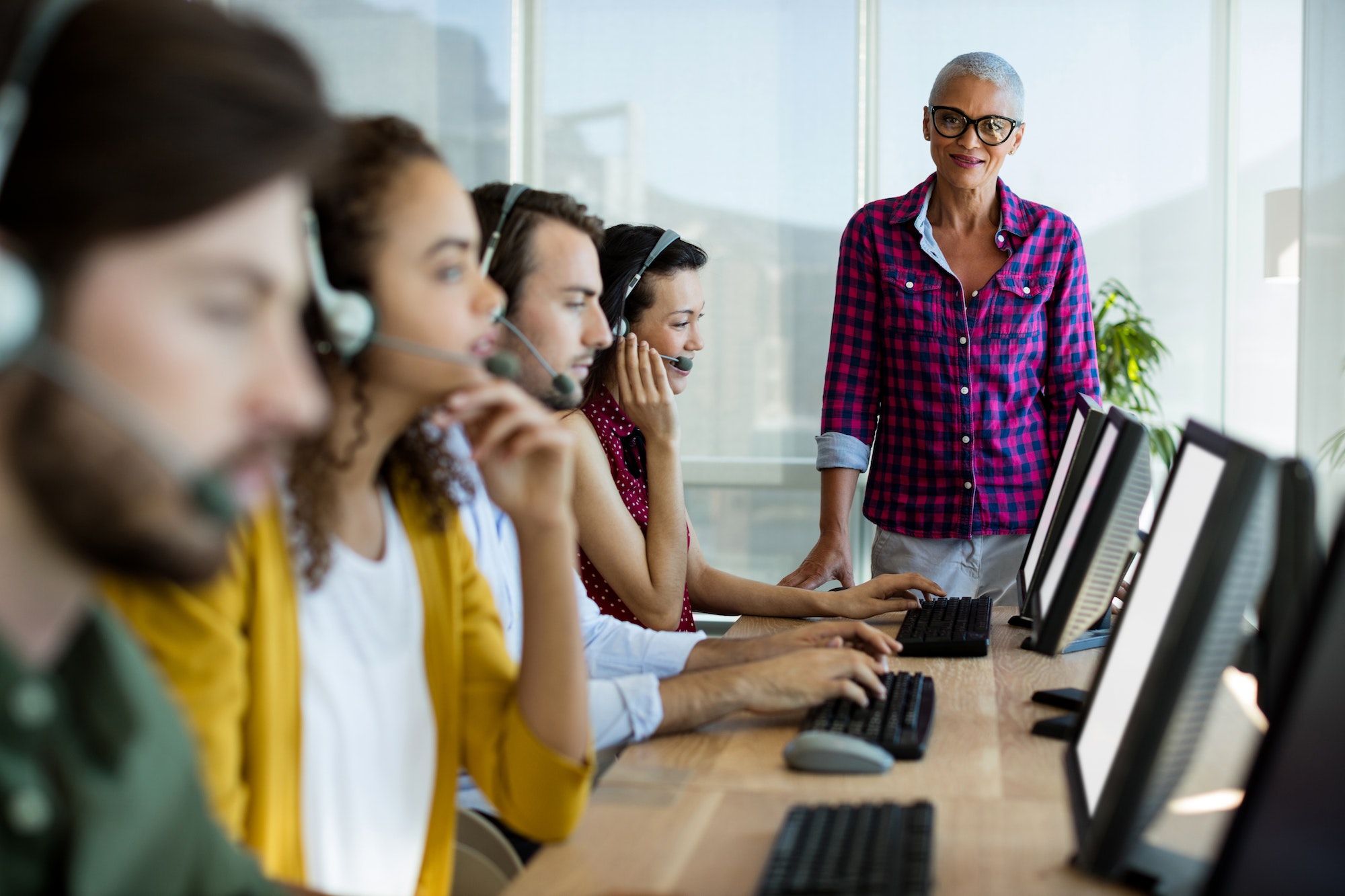 Customer service executive trainer monitoring her team